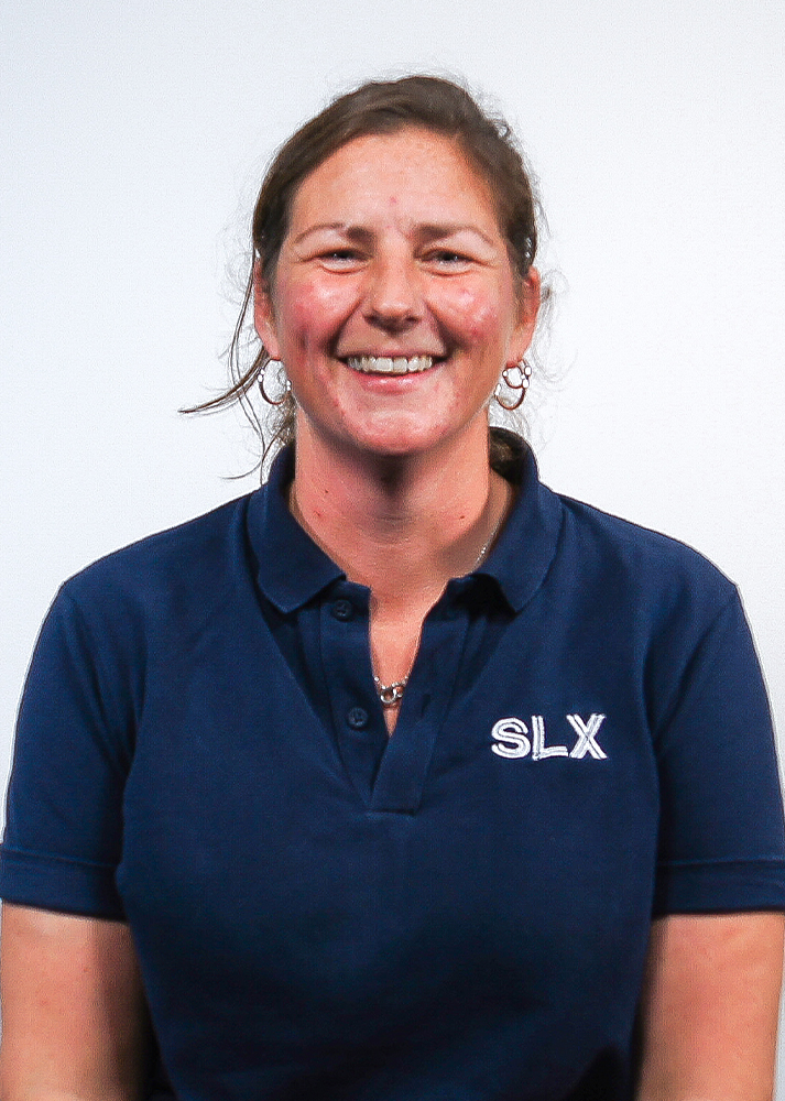 Jade White SLX Warehouse Supervisor smiling at the camera on a plain white background