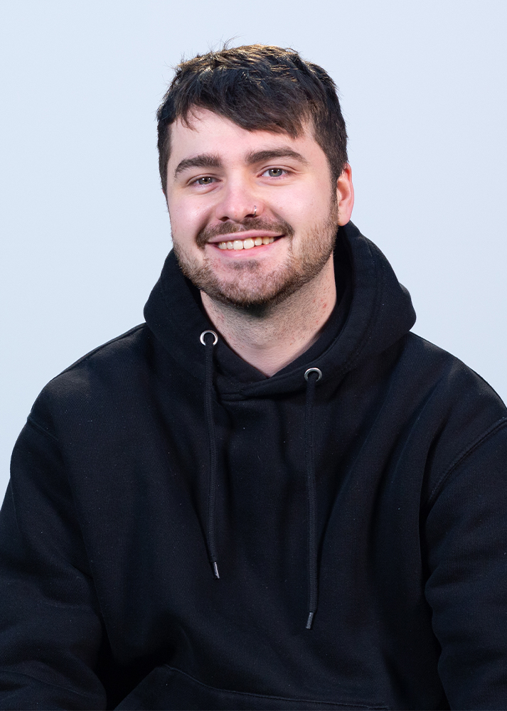 Jordan Shaddick smiling at the camera on a white background