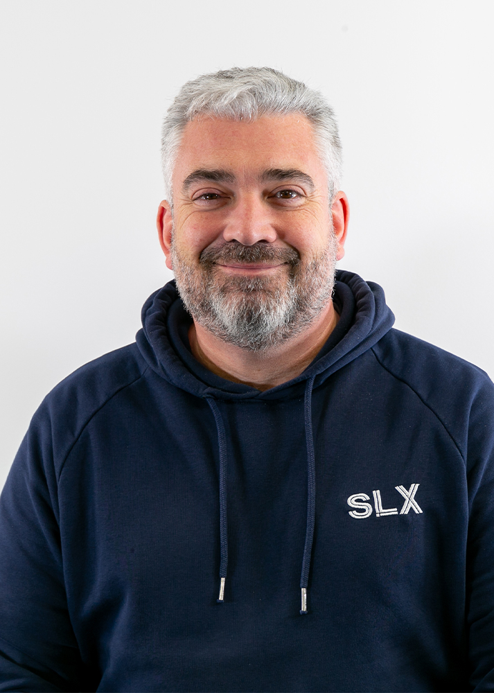 Kevin McCreanor, SLX Warehouse Supervisor, smiling confidently at the camera against a plain white background.