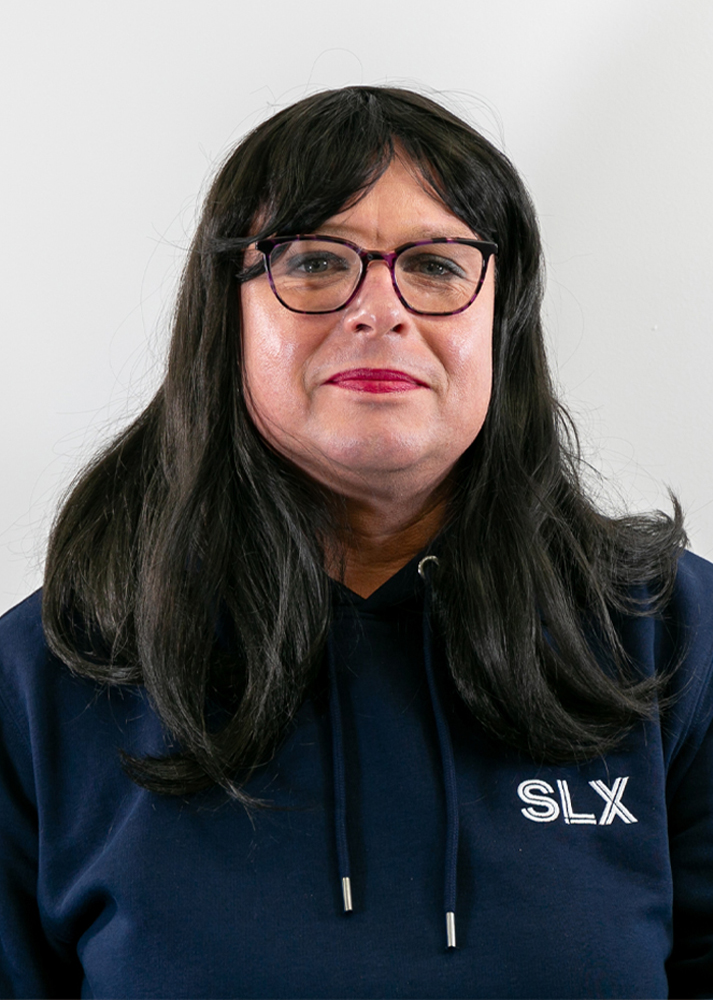 Simone Triggs smiling towards the camera on a white background